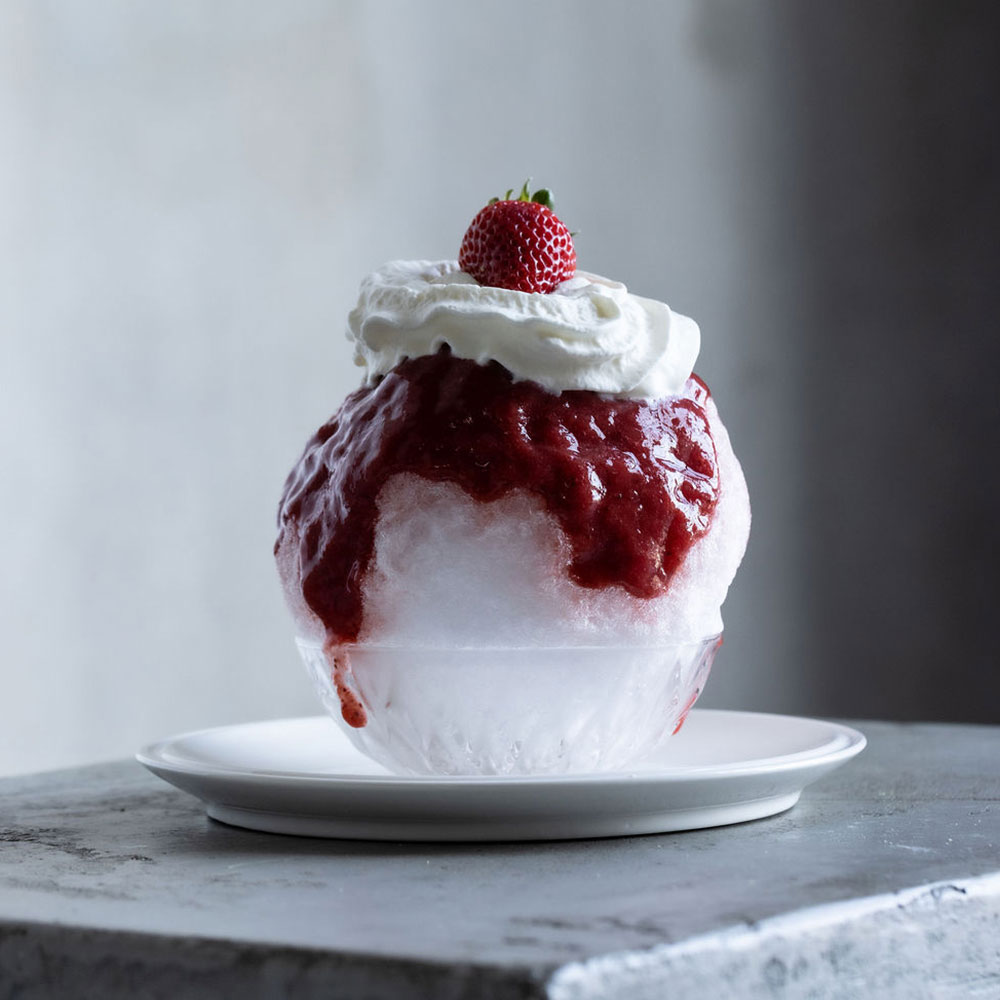 Shaved ice with strawberry and whipped cream topping